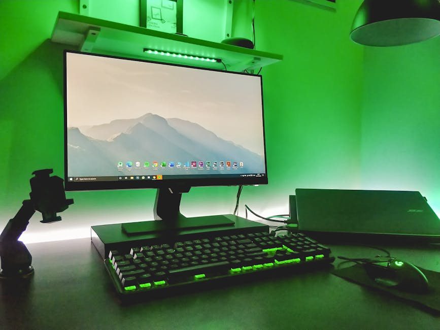 Stylish workspace featuring a desktop and ambient green LED lighting