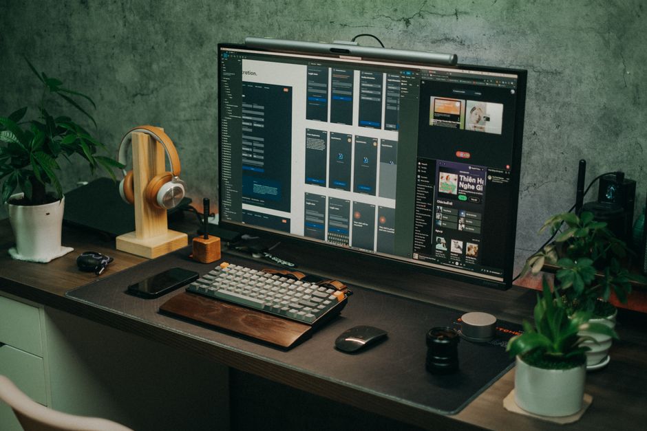 A sleek home office setup featuring a large monitor and keyboard